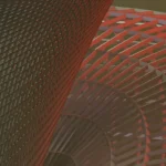 Abstract red spiral lattice sculpture with interwoven bands forming a twisting tunnel effect