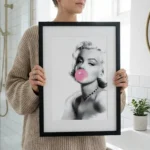 Woman holding A3 Marilyn Monroe Bubblegum print against wall