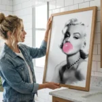 Woman holding very large Marilyn Monroe Bubblegum digital art print against wall