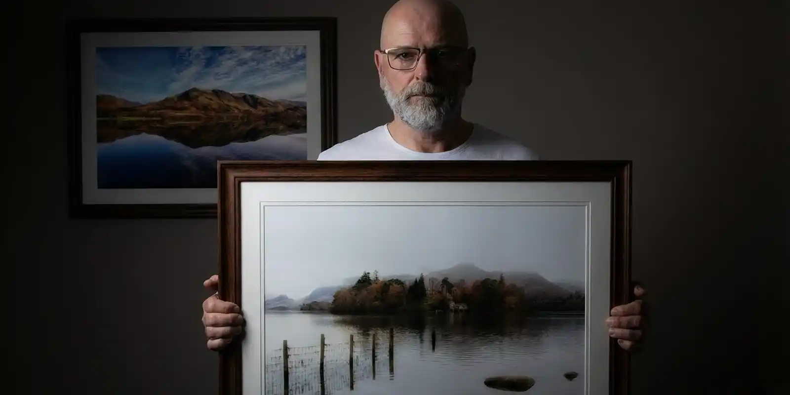 Michael Paul Bennett holding his Derwent Island Art Print