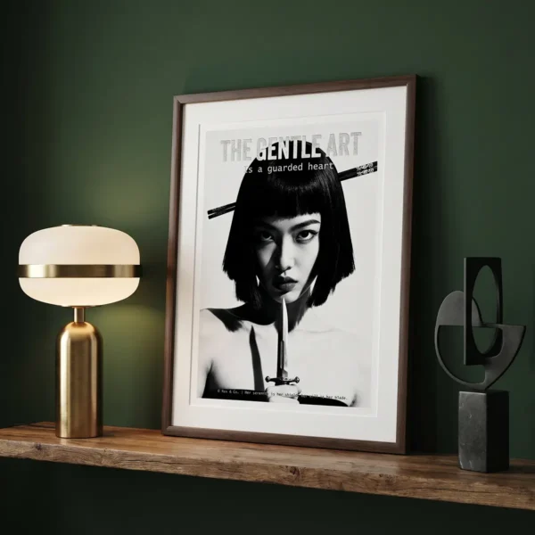 Framed black-and-white portrait on a wooden shelf beside a brass lamp and abstract sculpture against a green wall.