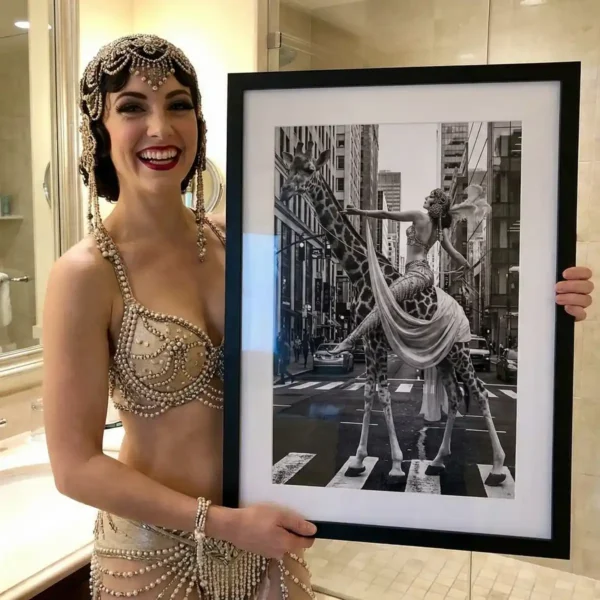Woman dressed as a 1920s flapper holding Woman on a giraffe black and white print