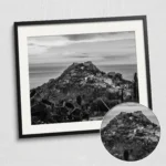 Close-up of a framed Taormina castle black and white digital wall art print by Mark Marsh, showing the medieval fortress ramparts and volcanic hillside detail.