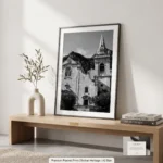 Framed black and white printable art of Chiesa di San Giuseppe in Taormina, Sicily—Baroque facade and bell tower with Monte Tauro rising behind, captured by Mark Marsh and displayed in a modern interior.