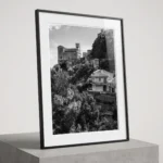 Savoca church on the hill black and white digital download print in a black frame, styled in a living room o with stone textures, capturing Sicilian Godfather heritage by Mark Marsh.