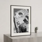 Corso Umberto clock facade black and white digital download print in a black frame, styled in a hallway with stone textures, capturing Sicilian street architecture by Mark Marsh.