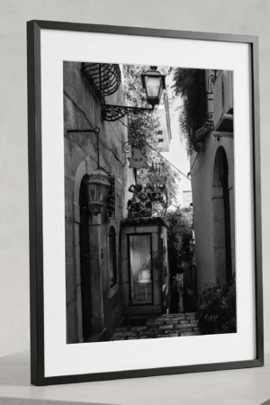 DIOR alley black and white digital download print in a black frame, styled on a stone plinth capturing Sicilian noir luxury by Mark Marsh.