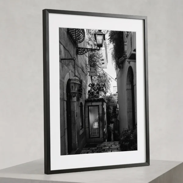 Dior Boutique black and white digital print by Mark Marsh DIOR alley black and white digital download print in a black frame, styled on a stone plinth capturing Sicilian noir luxury by Mark Marsh.