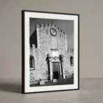 Framed black and white printable art of the Duomo di Taormina in Sicily—medieval limestone facade with rose window and main portal, captured by Mark Marsh.