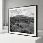 Mount Etna black and white digital download print in a black frame, styled in a living room or study with concrete and stone textures, capturing the Sicilian volcano by Mark Marsh.
