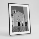 Framed Taormina Sant'Agostino black and white digital wall art print by Mark Marsh, showing the Gothic arched portal, stone rosette window, and checkered tile floor detail.