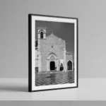 Sant'Agostino Taormina black and white digital download print in a black frame, styled on a shelf with stone textures, capturing Sicilian Gothic architecture by Mark Marsh.