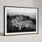 Framed Taormina rooftops black and white digital wall art print by Mark Marsh, showing the historic stone facades, terracotta tiles, and Ancient Theatre carved into the hillside detail.