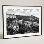Framed Savoca Sicily black and white digital wall art print by Mark Marsh, showing the crumbling stone houses, traditional balconies, and layered village detail.