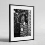 Framed Taormina Testa di Moro black and white digital wall art print by Mark Marsh, showing the sculpted ceramic face, trailing plant leaves, and rose-bordered house number tile detail.