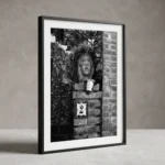 Framed Taormina Testa di Moro black and white digital wall art print by Mark Marsh, showing the sculpted ceramic face, trailing plant leaves, and rose-bordered house number tile detail.
