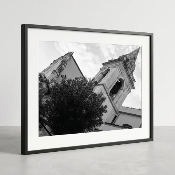 Tower of the Chiesa di San Giuseppe black and white print by Mark Marsh Framed Taormina bell tower black and white digital wall art print by Mark Marsh, showing the open belfry arches, decorative mouldings, and pyramidal spire detail.