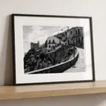 Framed Savoca Sicily black and white digital wall art print by Mark Marsh, showing the church on the hillside and wrought-iron street lamp detail.